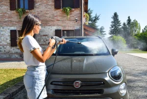 Using an industrial pressure washer to clean a car
