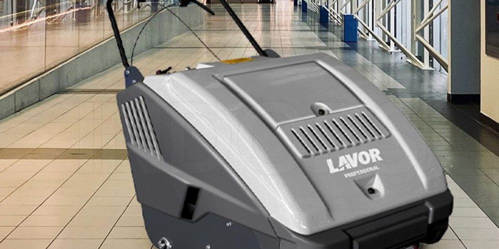 Unboxing a brand-new Lavor SWL 900 walk-behind industrial sweeper machine, ready for initial setup and assembly at a commercial facility.
