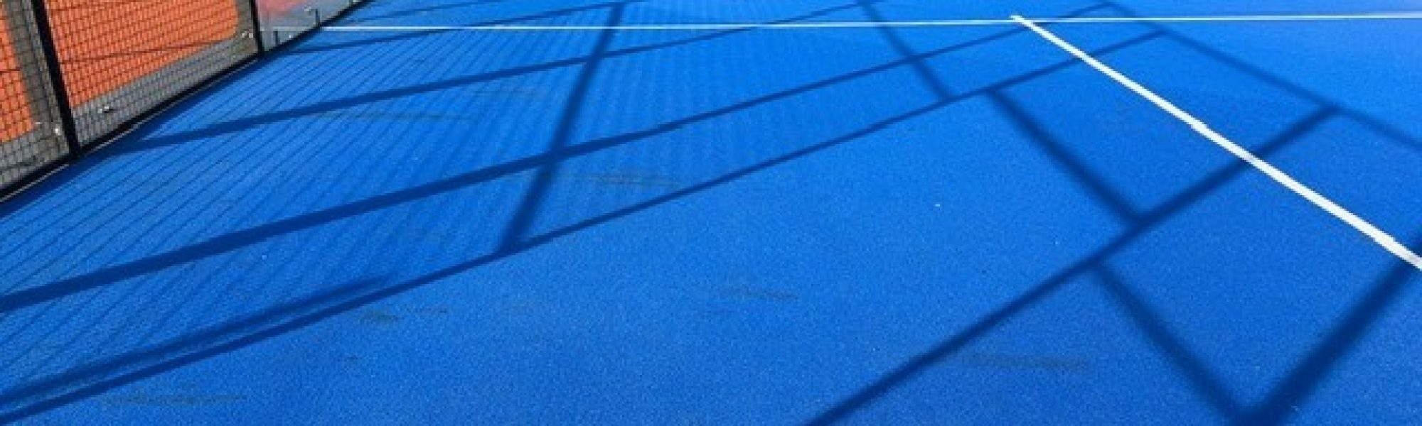 Soft-bristle central brush of a Columbus court sweeper combing synthetic turf fibers to prevent compaction.